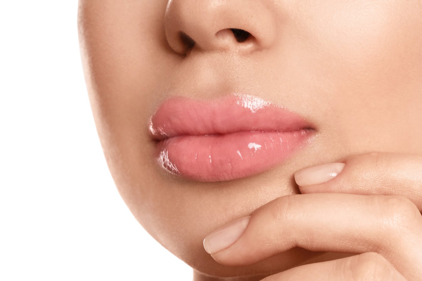 Young Woman with Beautiful Full Lips on White Background, Closeup